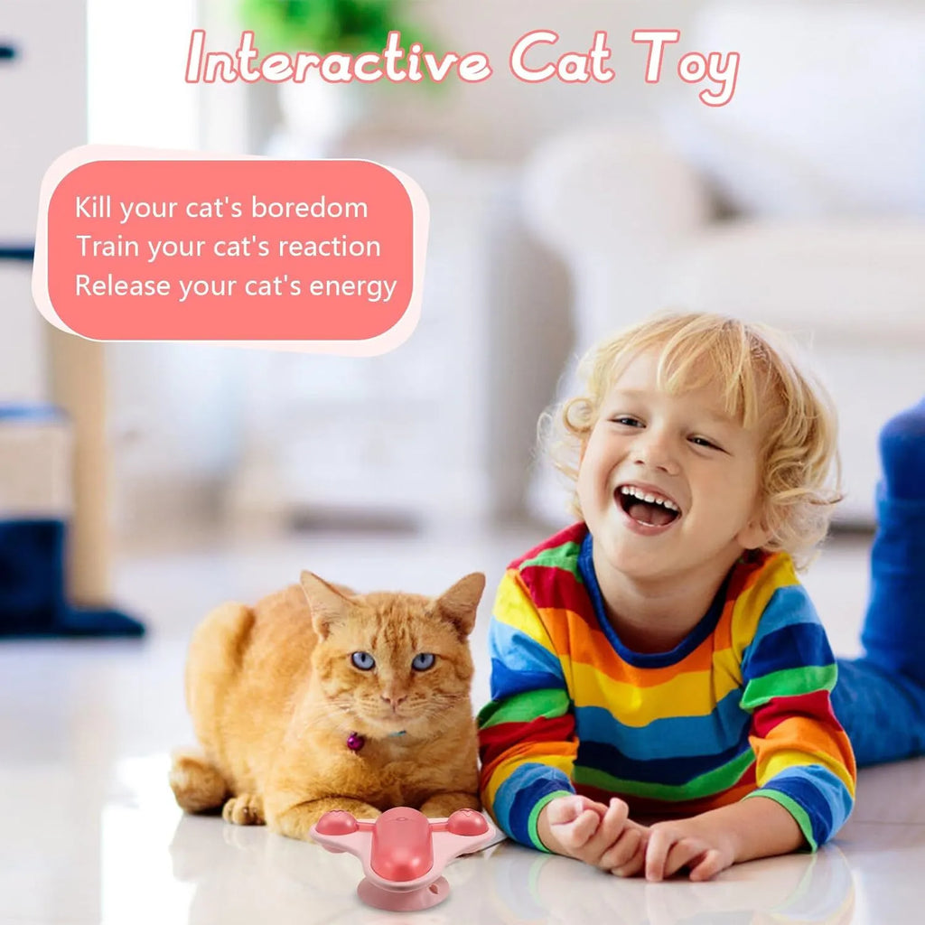 Blue interactive pet puzzle feeder with bell, catnip, and snack compartment on a suction cup base