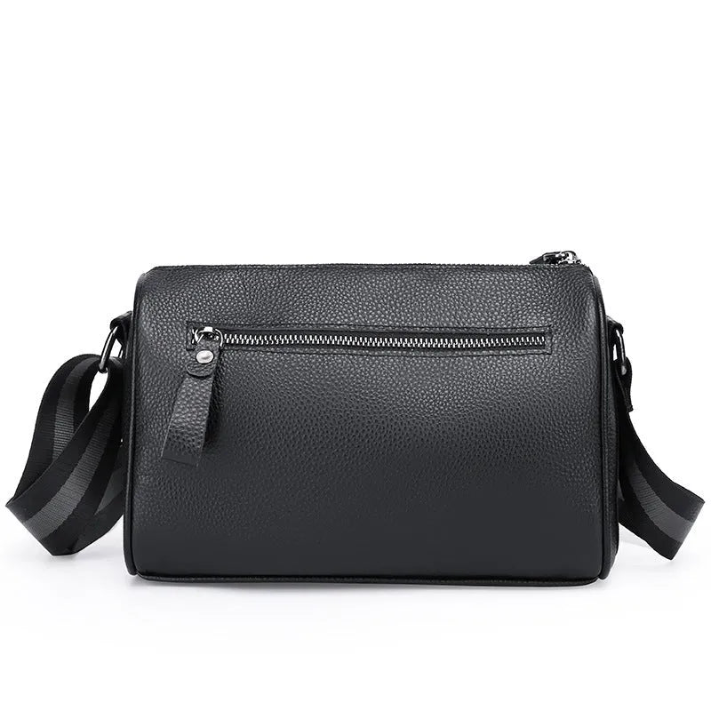 Black genuine leather one-shoulder crossbody bag showing its large capacity and crossbody strap.