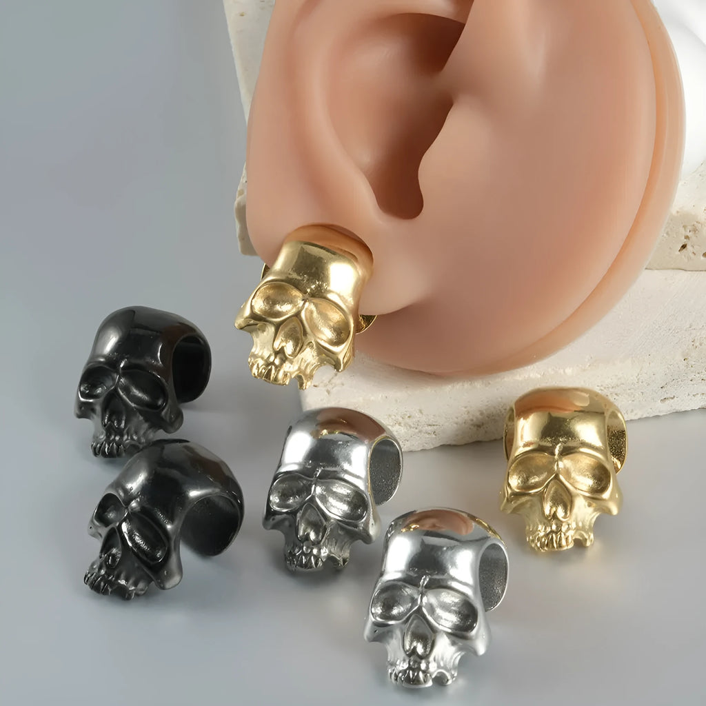 Geometric stainless steel earrings combining hollow skull and Buddha motifs with electroplated finish