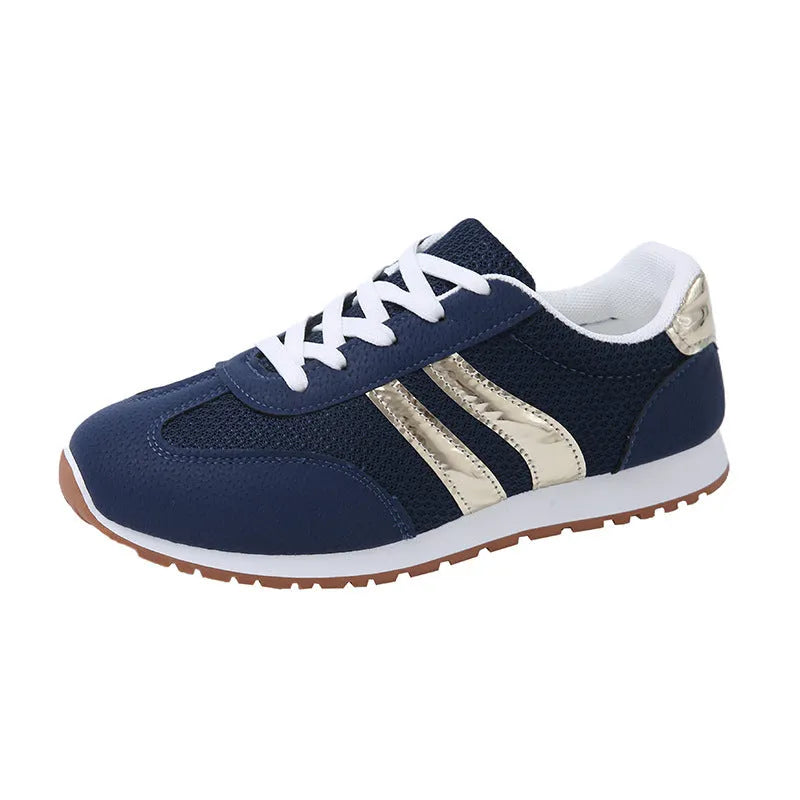 Blue women's artificial leather tennis shoes with cross shoulder straps and flat rubber sole.