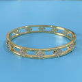 Women's hollow bracelet with four-leaf clover charm and zircon inlay detailing on copper-plated gold