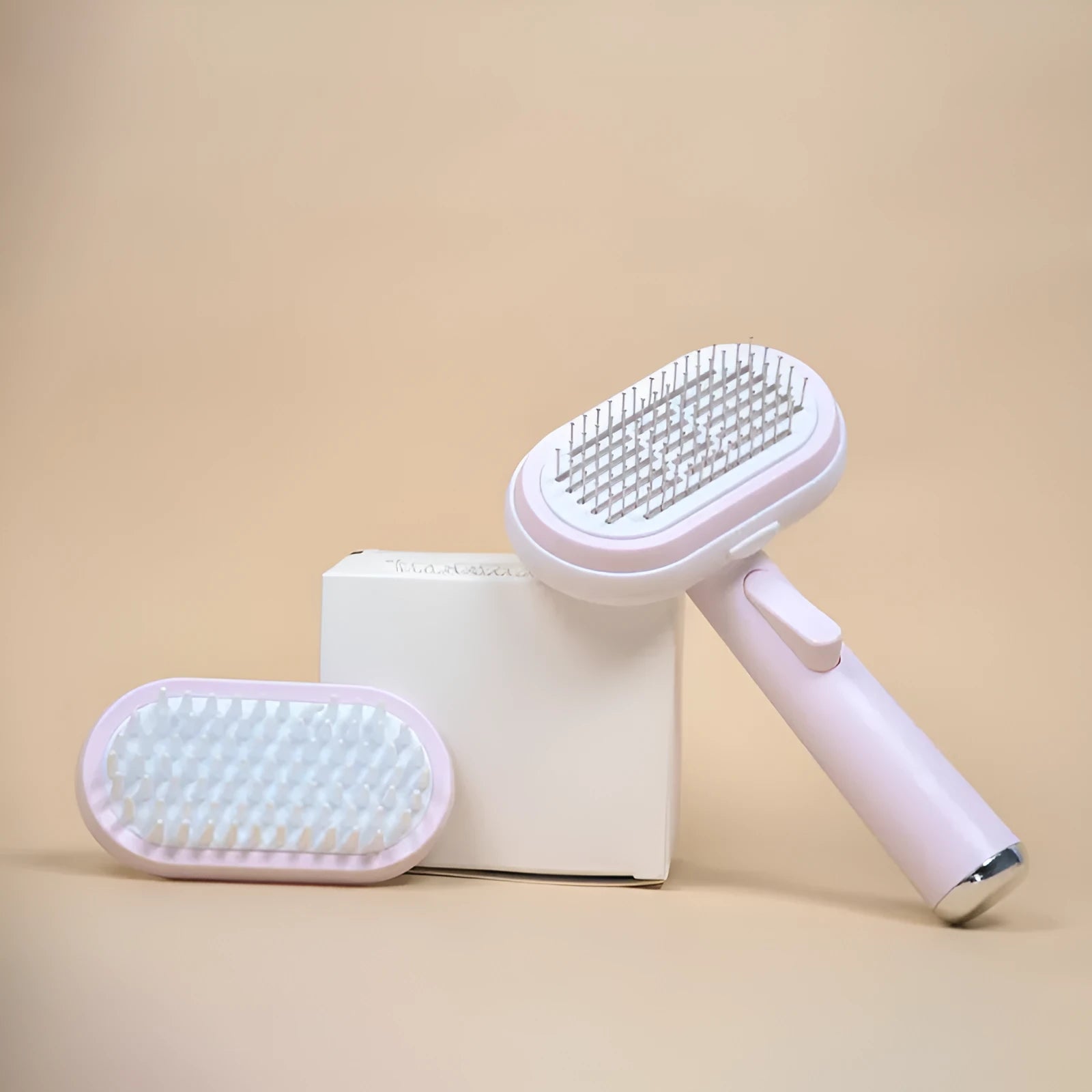 Blue and pink pet hair removal brush with steel needles on a light background