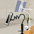 Flexible black phone and tablet mount holder with suction base and adjustable arm on a kitchen counter.