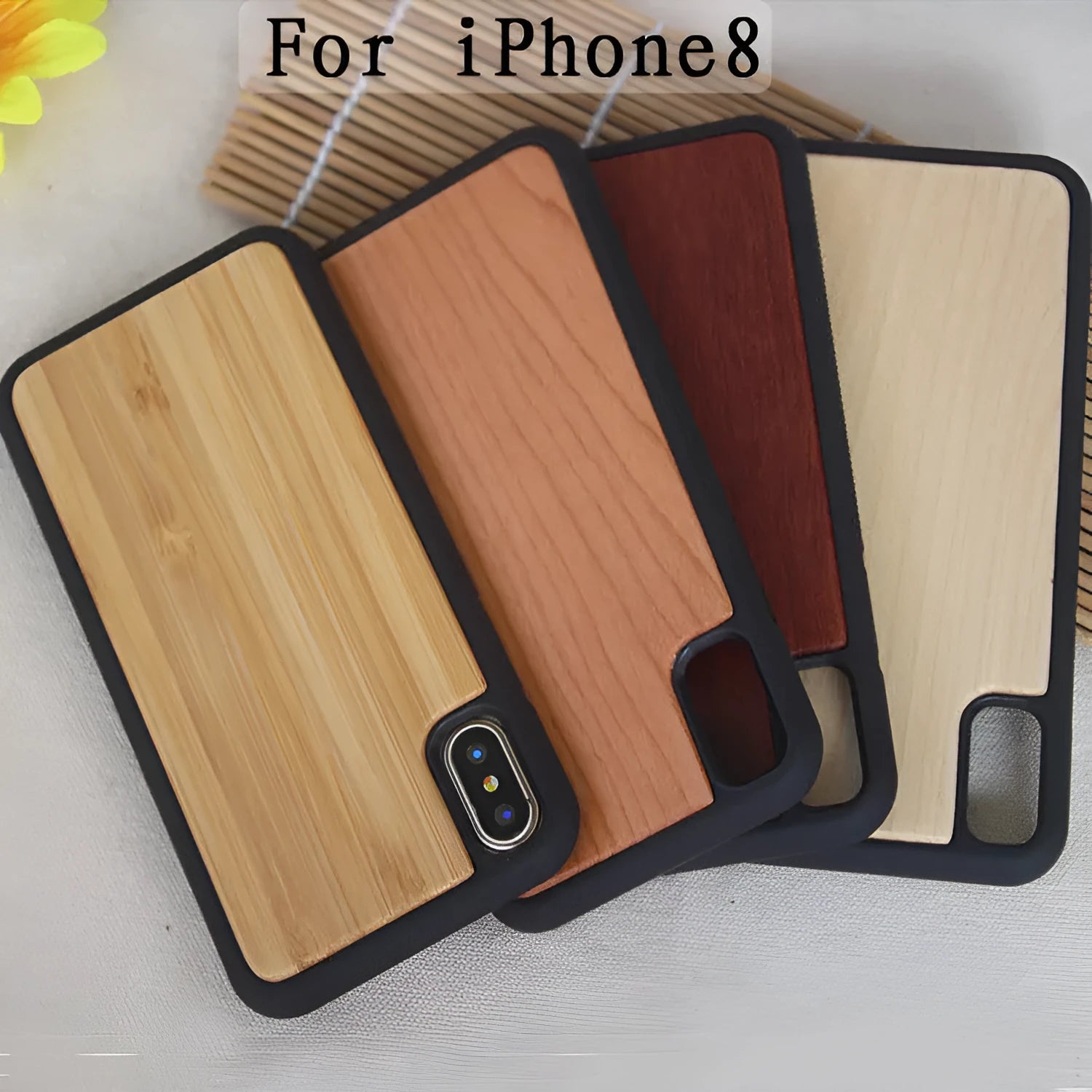 Wooden iPhone case with carbonised bamboo back and black TPU sides on a wooden table.
