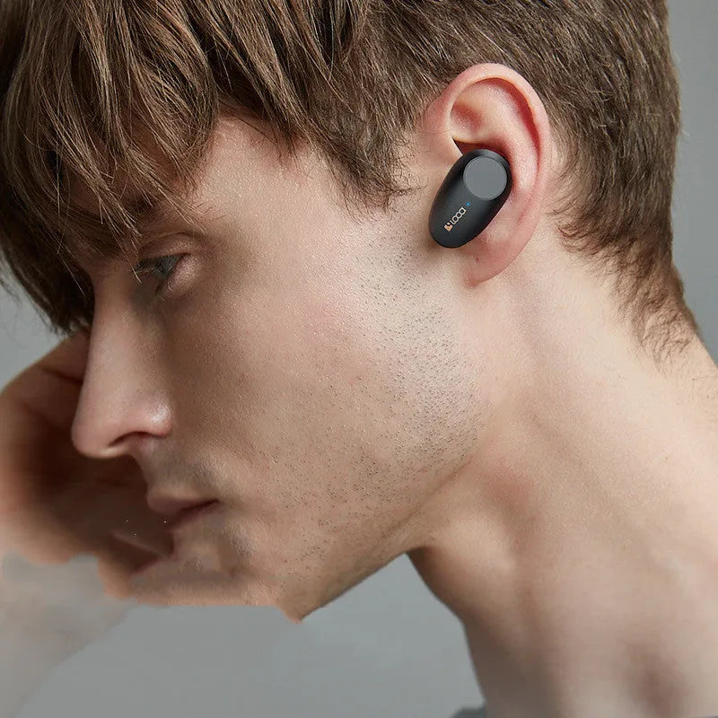 Black wireless Bluetooth stereo headset with charging case showing earbuds with rubber ear tips