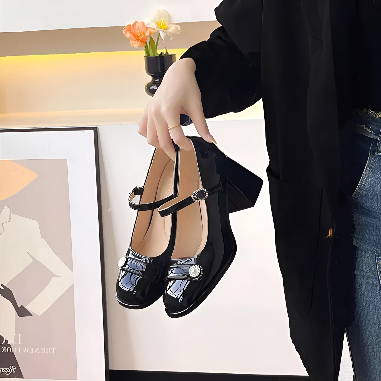 Women's black patent leather chunky heel shoes with round toe and buckle fastening, shown in a wide fit style.