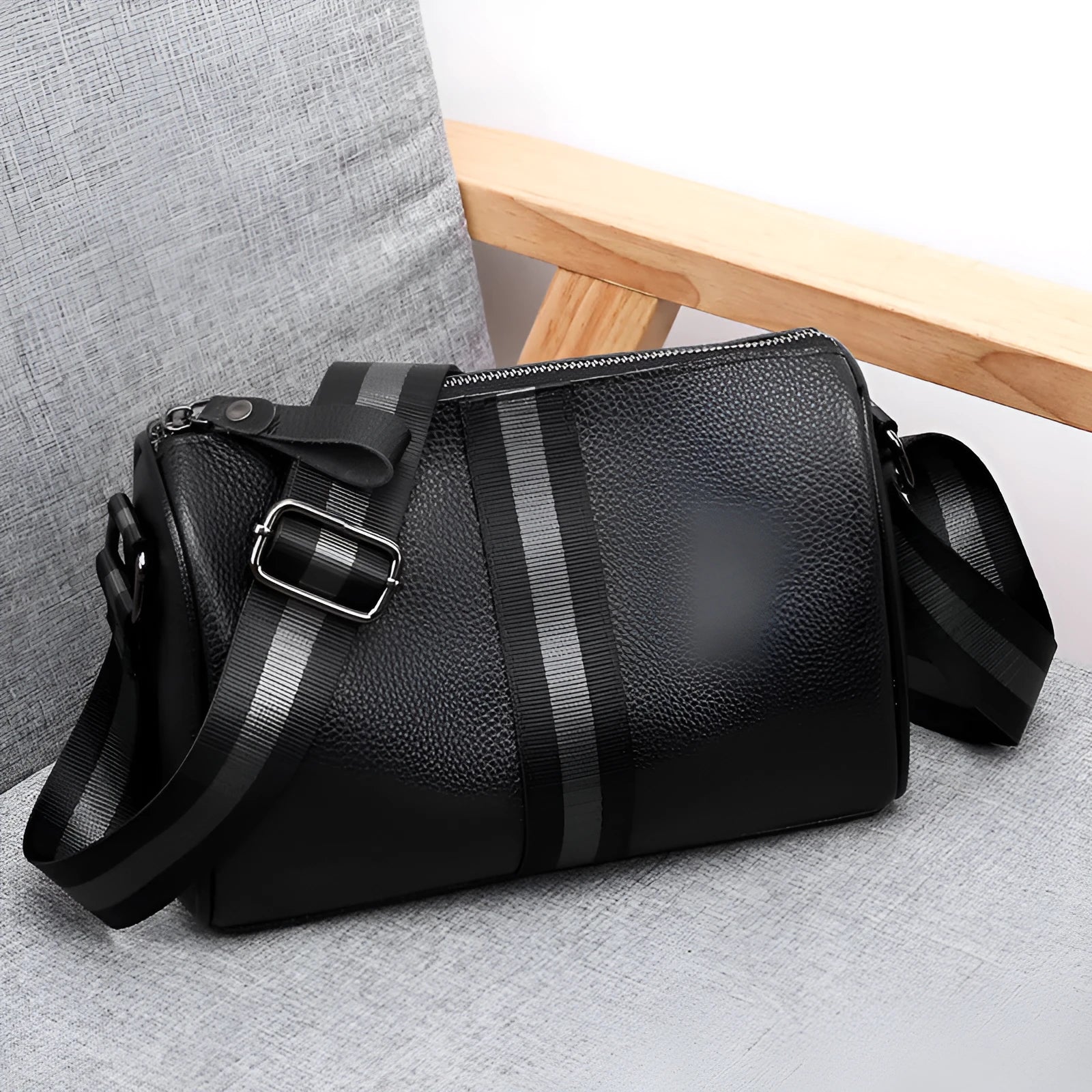 Black genuine leather one-shoulder crossbody bag showing its large capacity and crossbody strap.