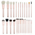 26 pink makeup brushes with wood handles arranged in a PU travel pouch.