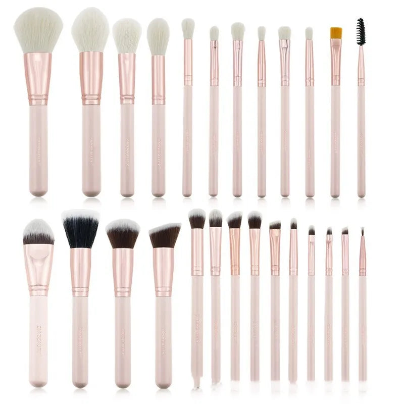 26 pink makeup brushes with wood handles arranged in a PU travel pouch.