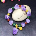 Women's natural amethyst shaped bead bracelet with a fu character charm.
