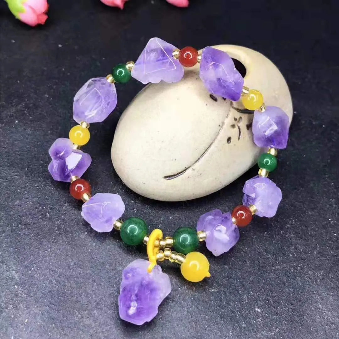 Women's natural amethyst shaped bead bracelet with a fu character charm.