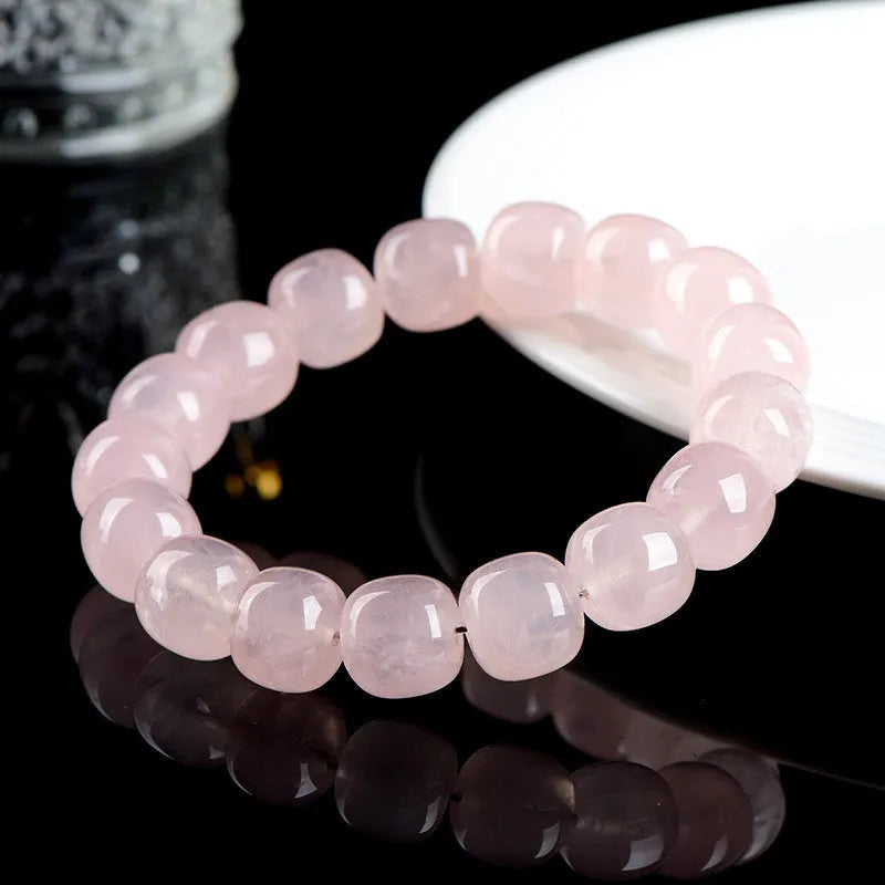 Pink bamboo crystal barrel bead bracelet with geometric 11mm-12mm beads on a wrist.