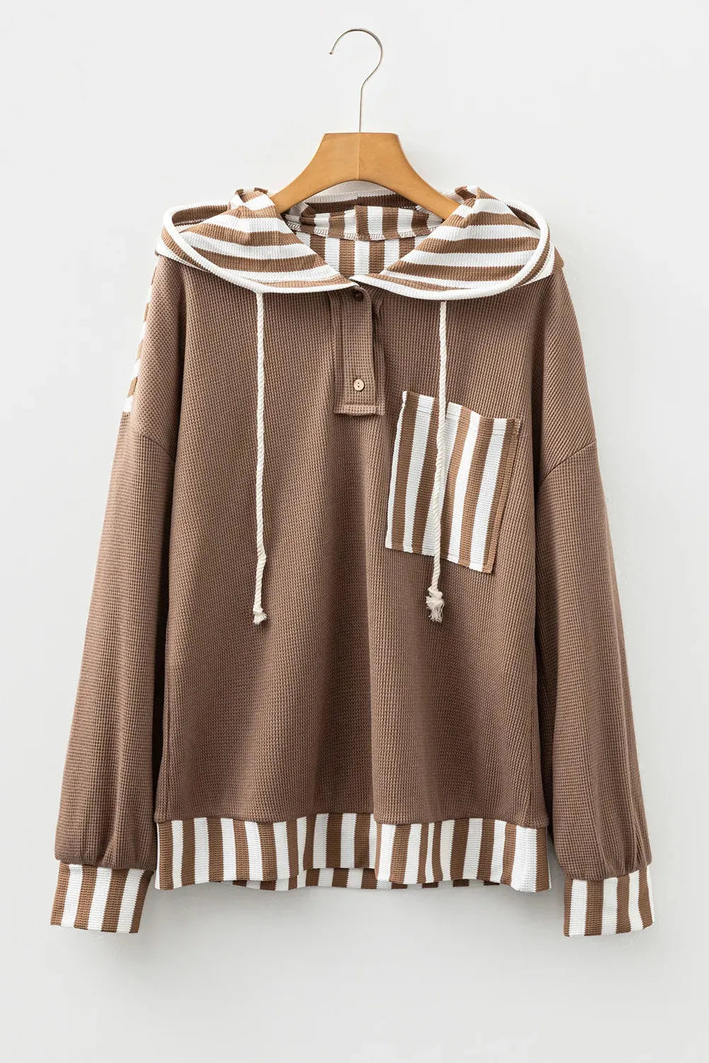 Straw yellow hoodie with waffle texture fabric, striped patchwork design, and button neck closure.
