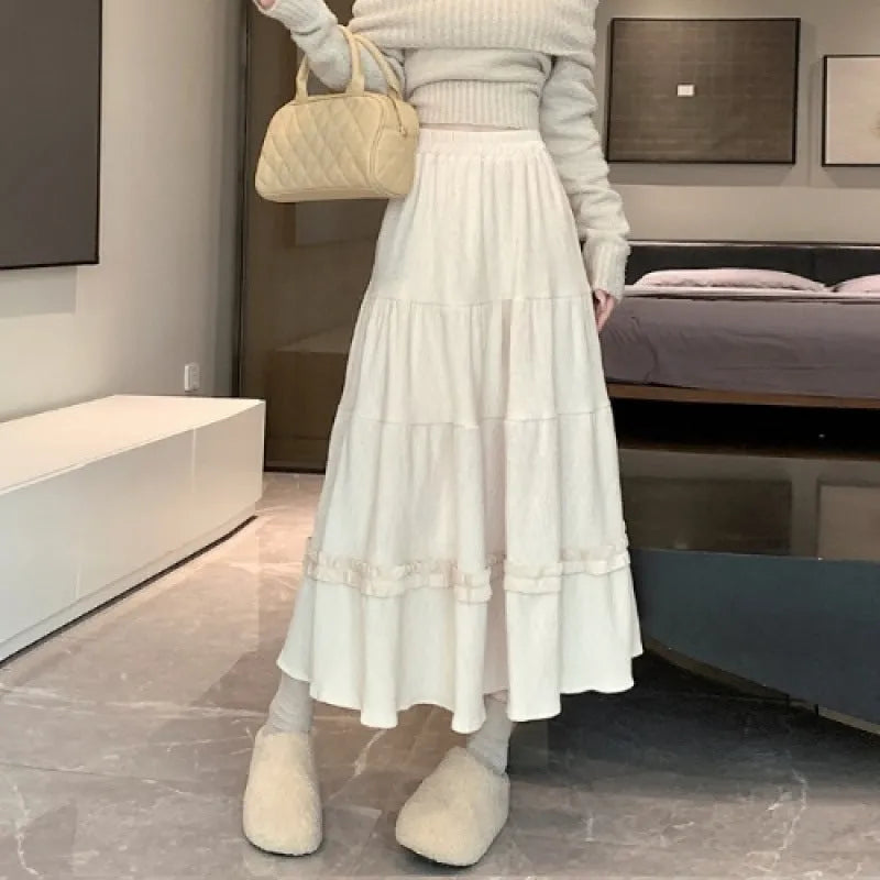 Korean style corduroy A-line midi skirt with an elastic waistband in a solid colour.