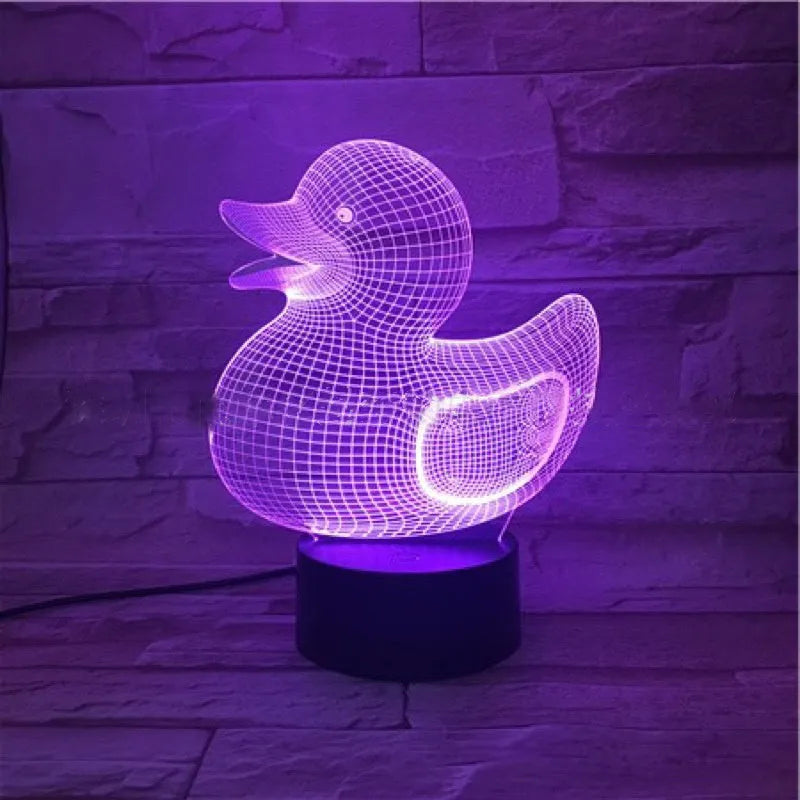 Little yellow duck 3D night light with multi-colour LED glow on an ABS base, showing remote control.
