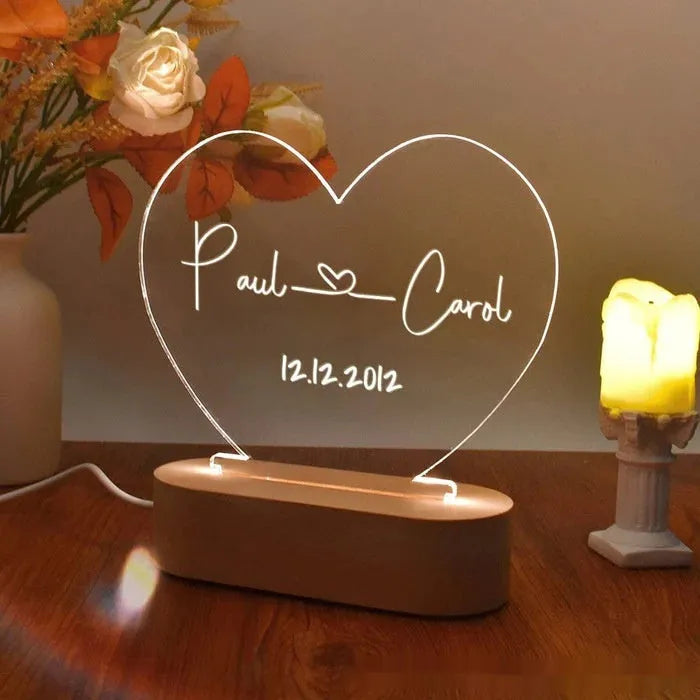 Custom engraved acrylic night light with LED base, showing personalised names and date.