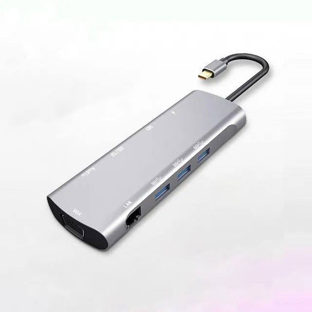 Grey aluminium USB-C docking station with HDMI, VGA, USB ports and a short connecting cable
