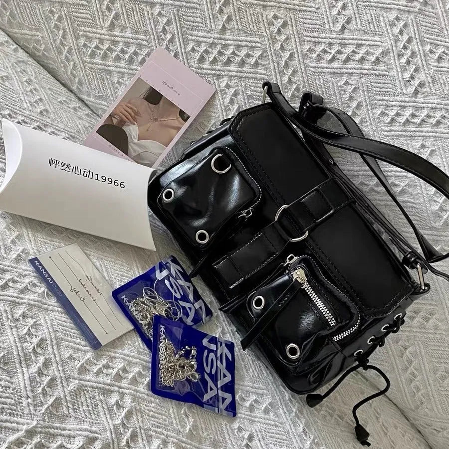 Black PU leather underarm baguette bag with adjustable shoulder strap shown in crossbody position