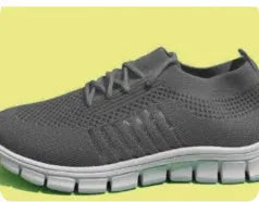 Women's casual breathable mesh flat shoes in pink with front tie and low heel on a light background.