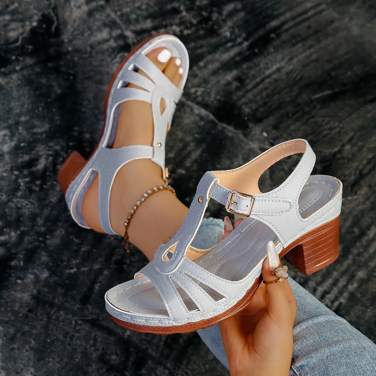 Women's black peep toe wedge sandals with a buckle fastening and platform sole.