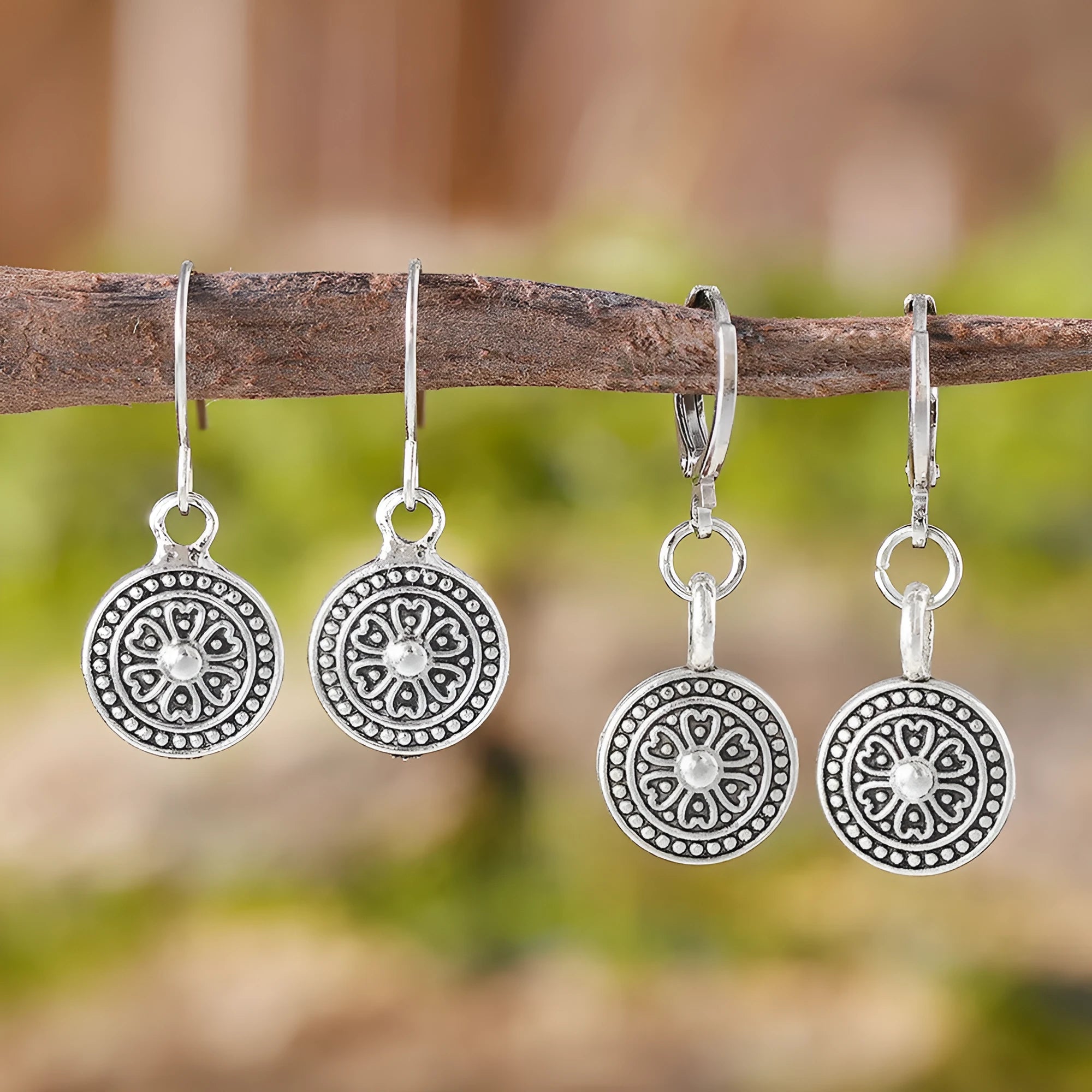 A pair of bohemian retro geometric earrings with a distressed finish and round elements.