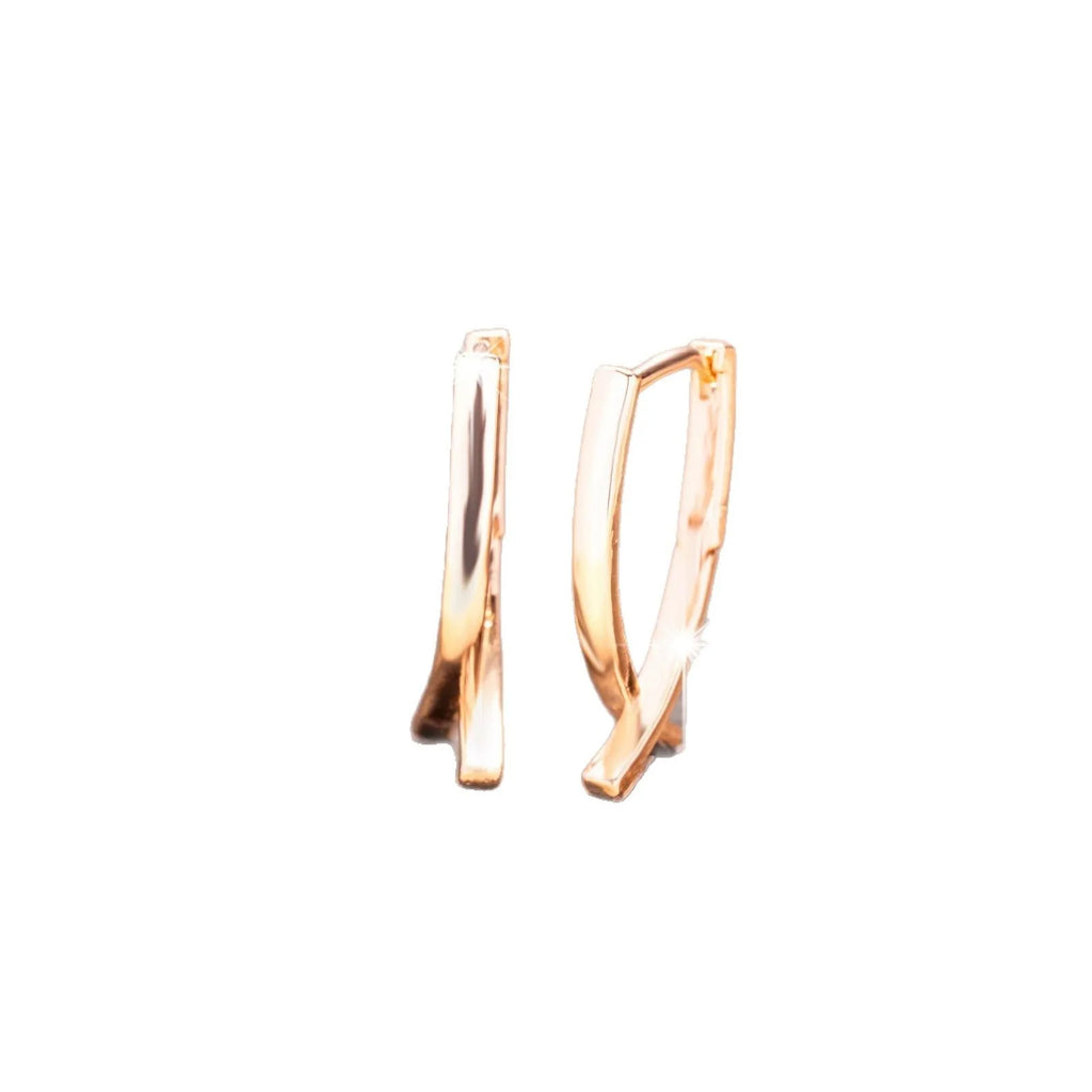 Rose gold cross shaped earrings with polished finish on copper material