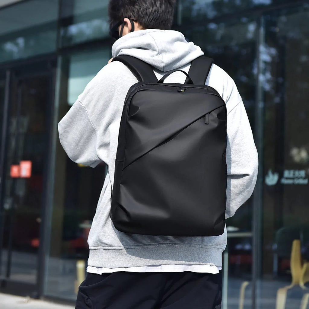 Large black waterproof PU leather backpack for men with sewing thread detailing and computer bag