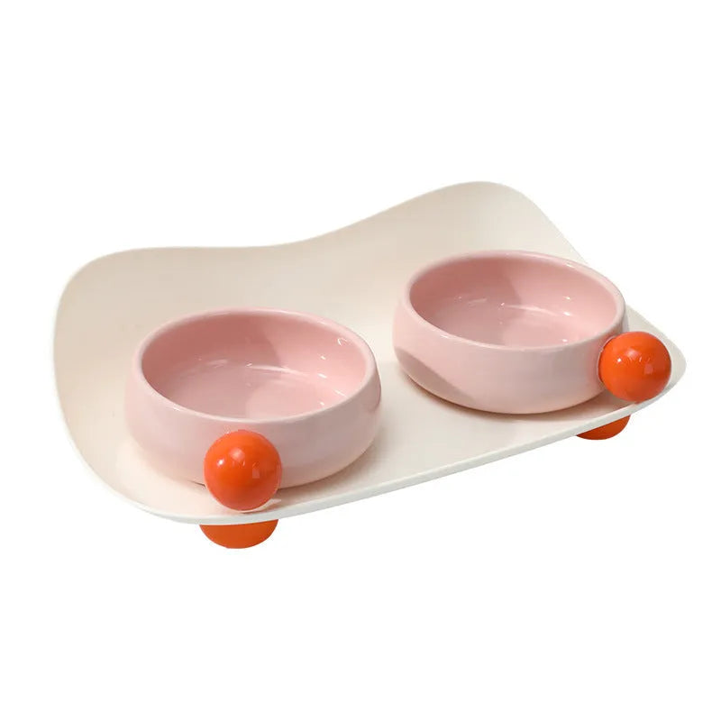 Double raised ceramic pet feeding bowl set with non-slip base in pink colour