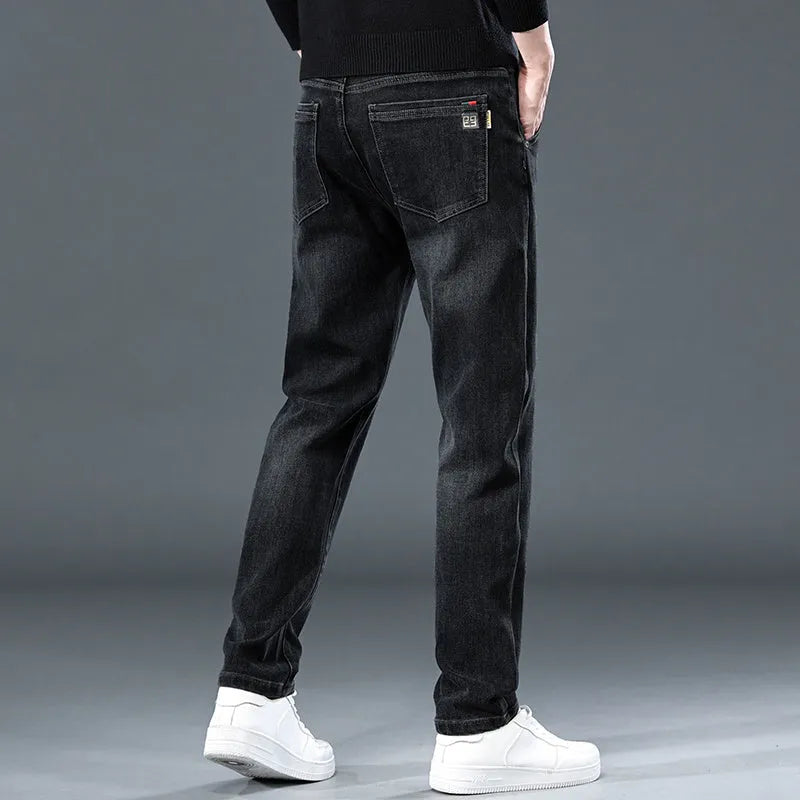 Blue grey slim straight casual trousers with a mid-waist and elastic comfort on a neutral background.