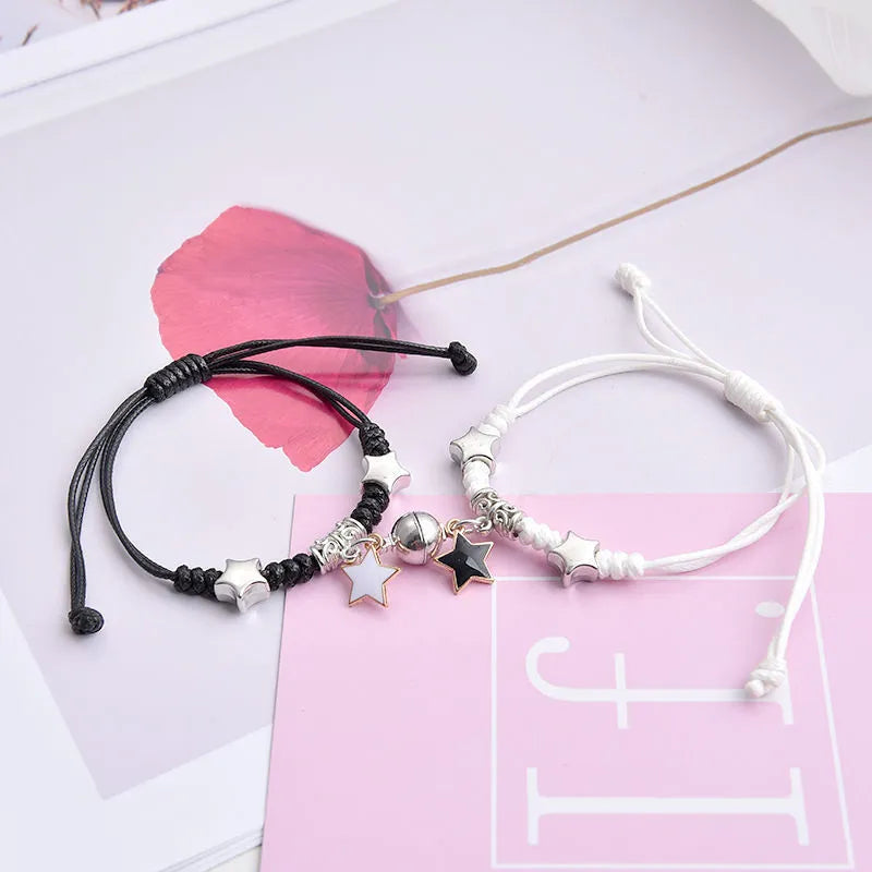 Magnetic couple bracelet pair with alloy electroplating in various designs including clover and crown patterns