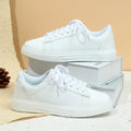 Women's beige brown platform skate sneakers with cross-strap detail and chunky rubber sole.