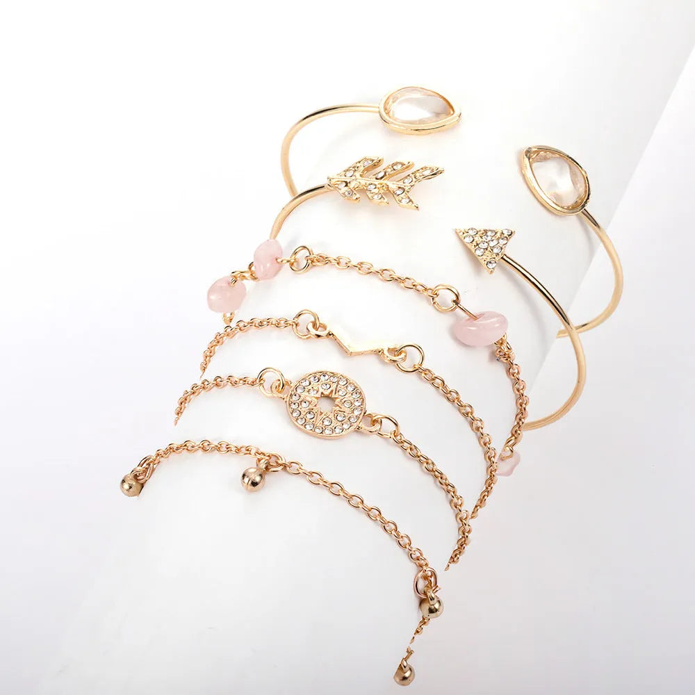 Golden bracelet charm set with six pieces including V-shape, arrow, water drop and drill spot designs