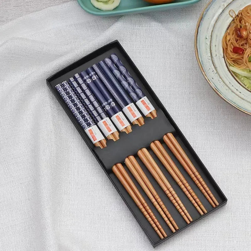 Set of five pairs of bamboo chopsticks with colourful Japanese lucky cat pattern design.