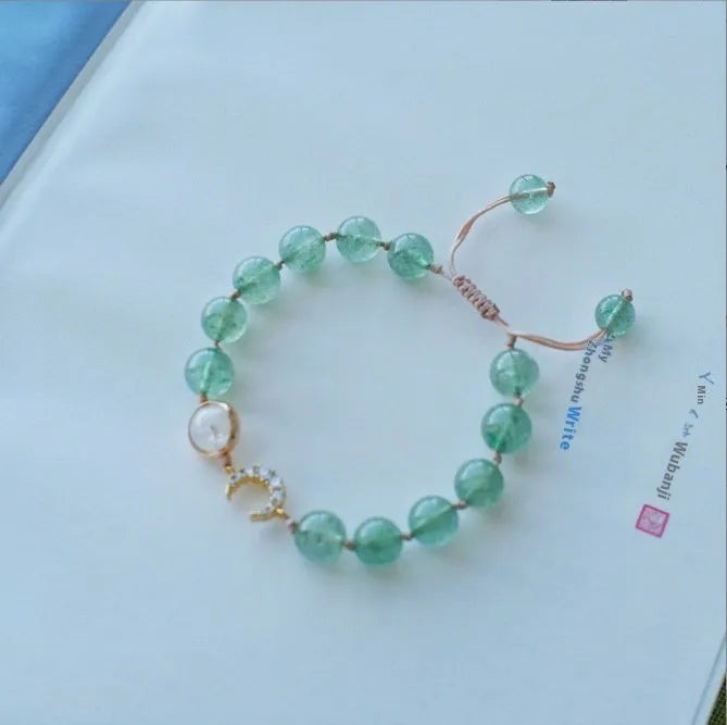 Handmade natural strawberry quartz crystal bracelet for women with moon and pearl bead designs.