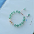 Handmade natural strawberry quartz crystal bracelet for women with moon and pearl bead designs.