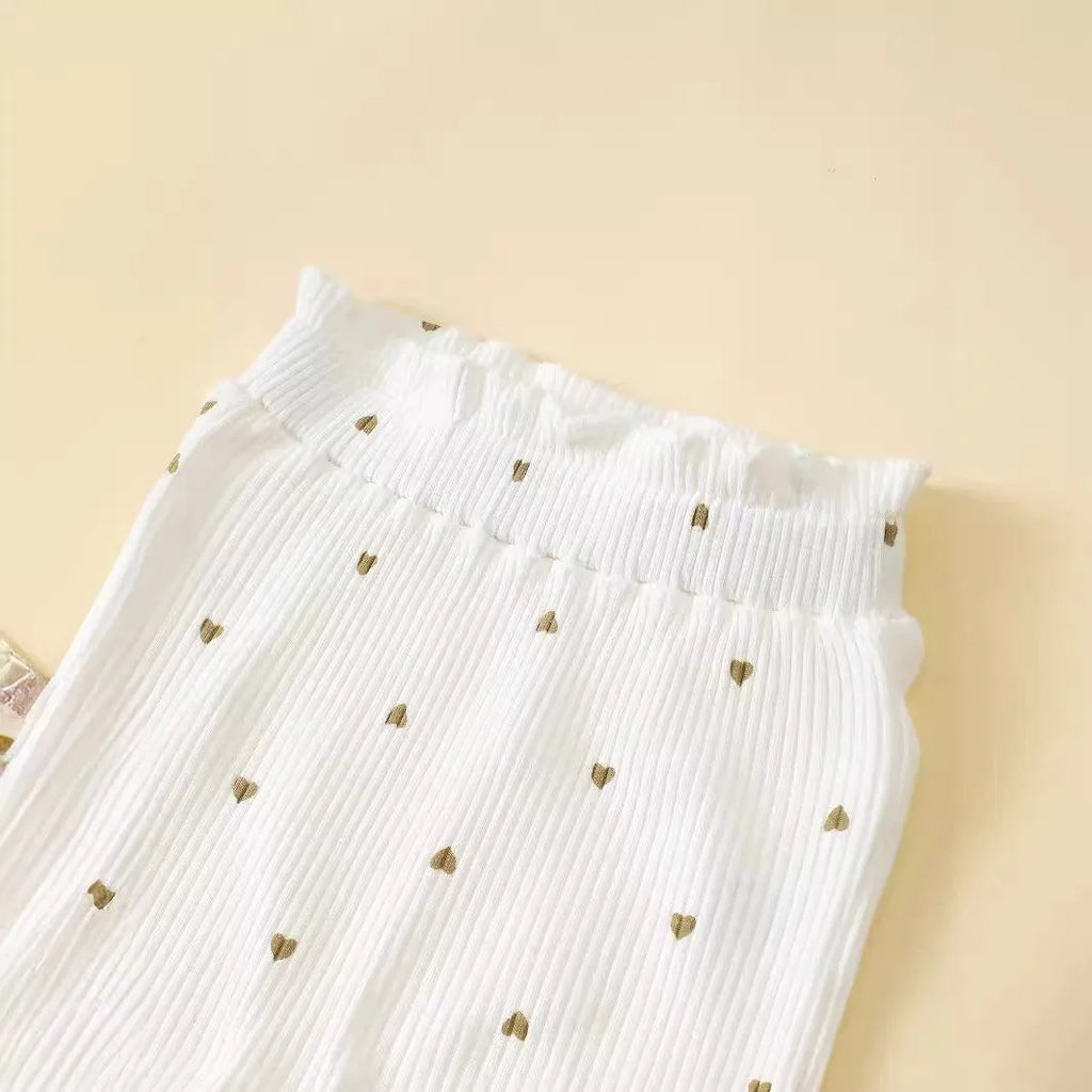 White cotton baby suit three-piece set with top, long pants, and hair tie showing sunken stripe stitching