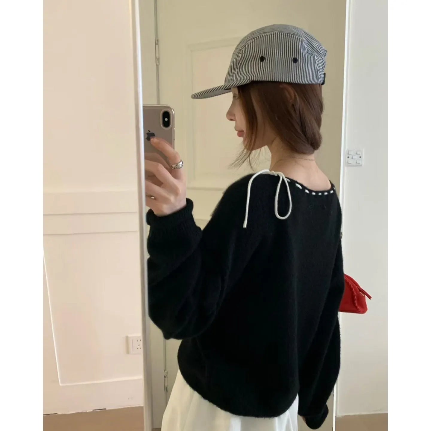 Grey loose-fitting women's knitwear pullover on a hanger