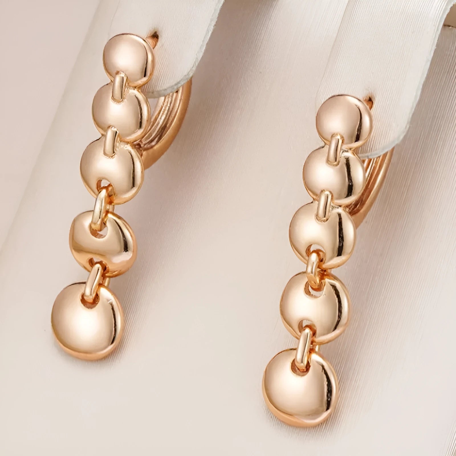Gold coloured woven copper circle drop earrings with retro design