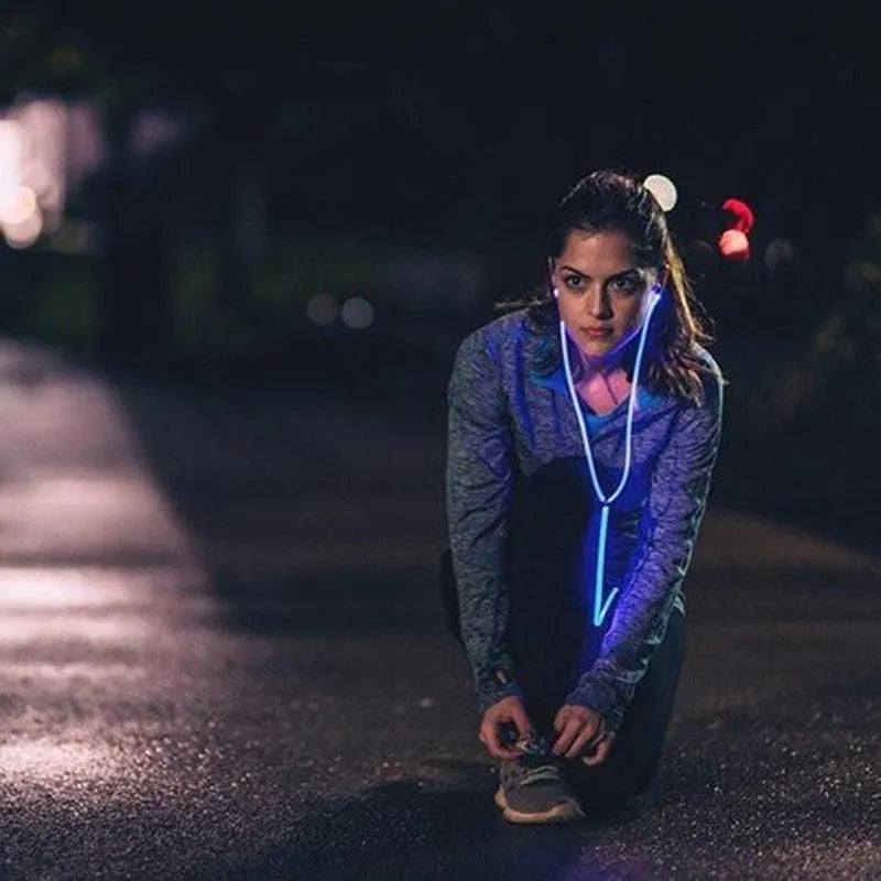 Blue light-up LED earphones with aluminium shells, remote control, and 3.5mm plug on a white background.