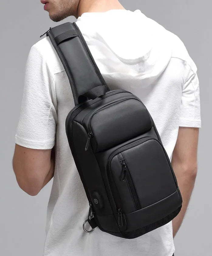 Black PVC outdoor leisure shoulder bag with internal organiser pockets and air cushion strap