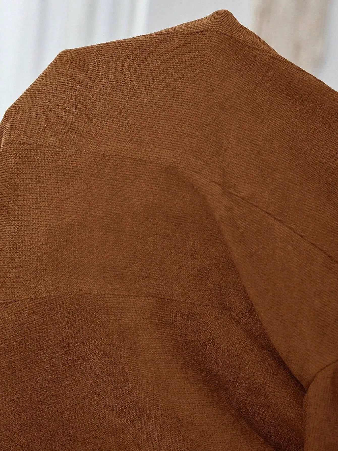 Brown single-breasted leisure suit coat with lapel collar and long sleeves on hanger