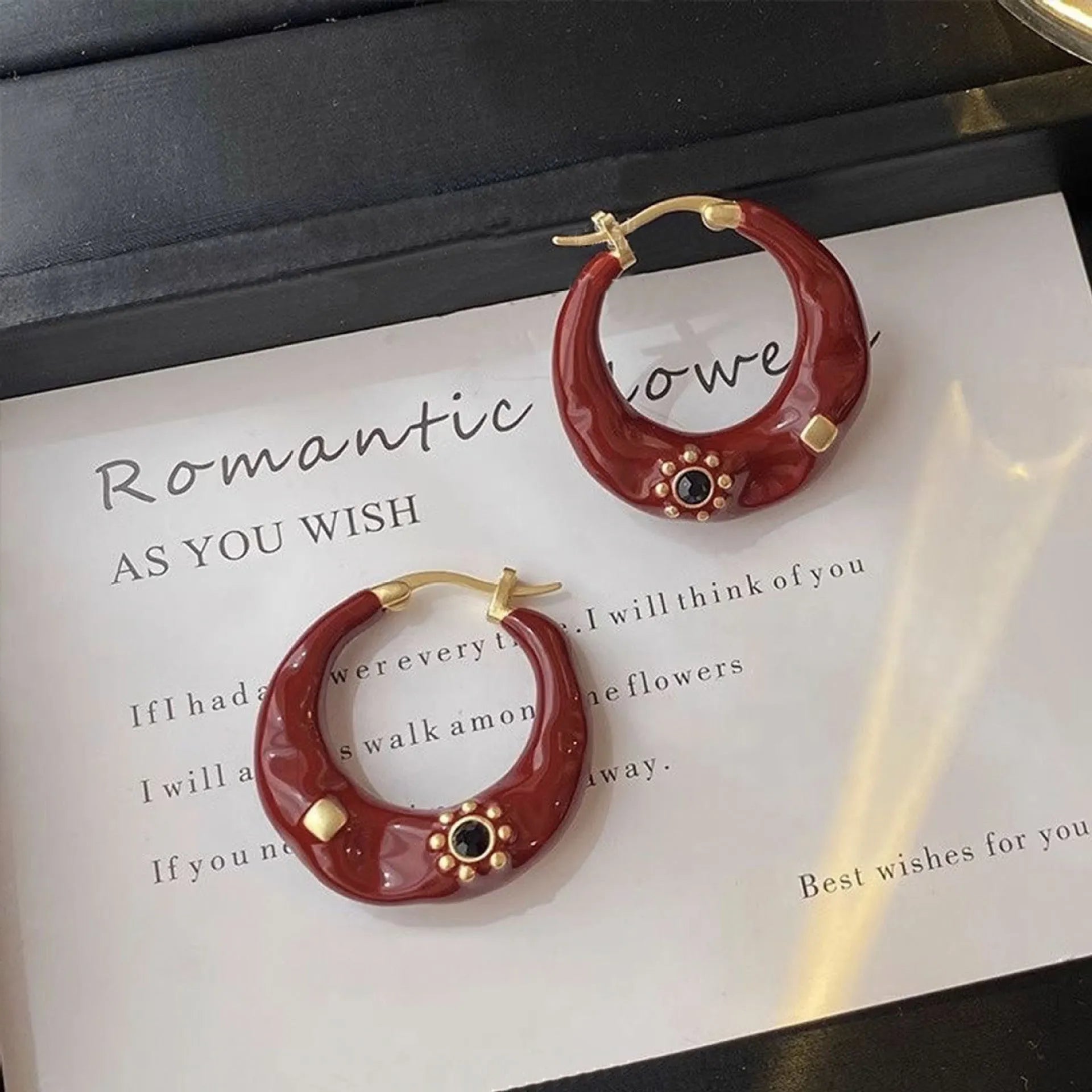 Hong Kong style retro ear studs with dripping oil finish and rhinestone detail in black and red colours