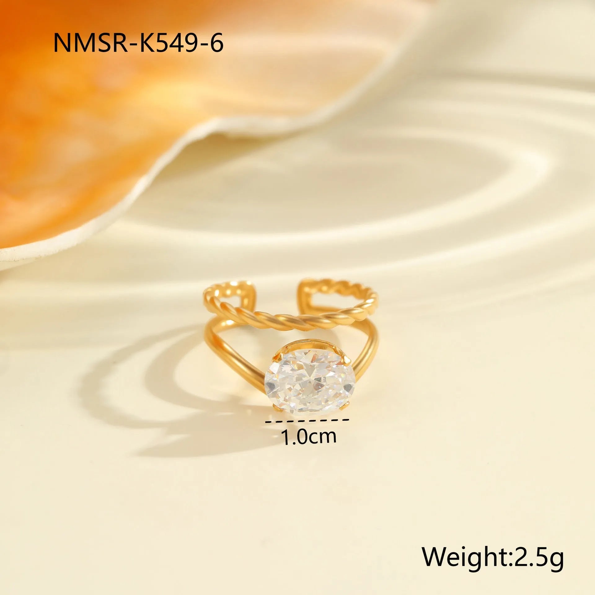 Gold-plated geometric stainless steel ring with inlaid zircon stones on a white background.