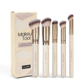 Five apricot coloured makeup brushes with synthetic bristles including angled blusher brush