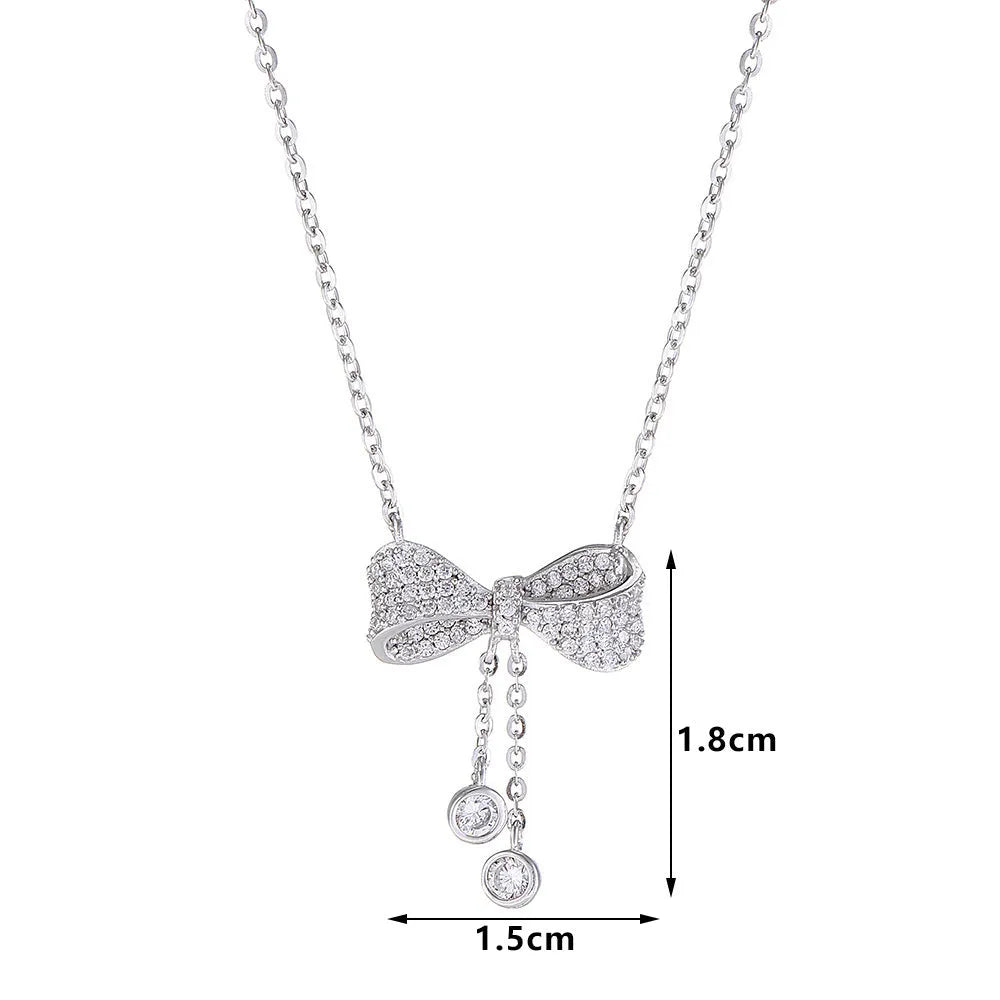 S925 sterling silver bow pendant necklace with O-ring chain on grey background