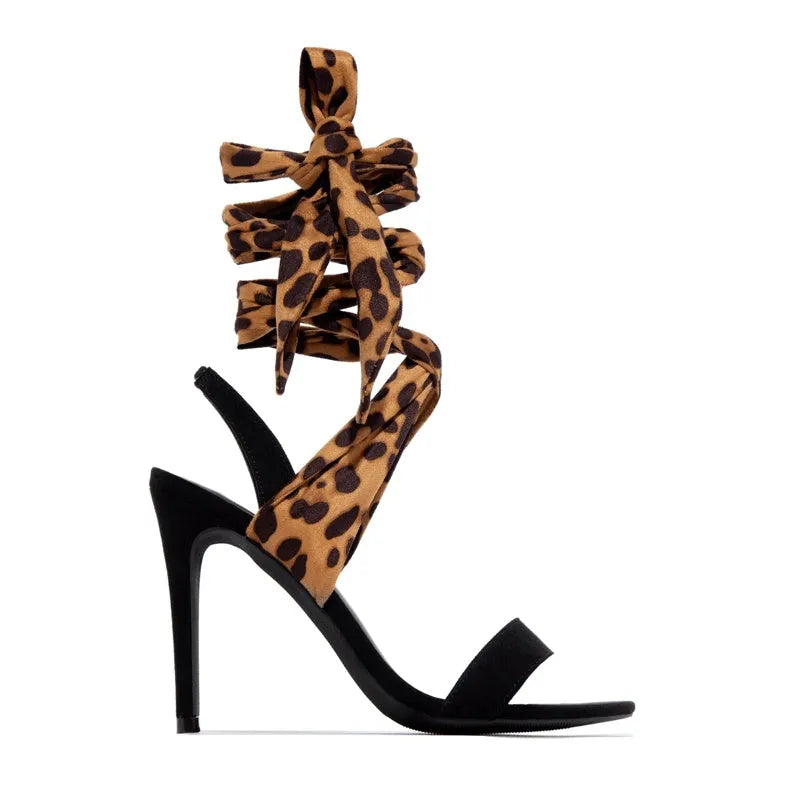 Light brown leopard print women's high heels with cross straps and a thin high heel.