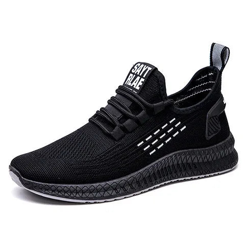 Men's low-top black casual sports shoes with cross strap detail and Flying Weave upper on a wear-resistant sole.
