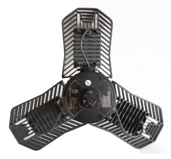 Waterproof industrial foldable LED garage lamp with die-cast aluminium housing shown in a workshop setting.