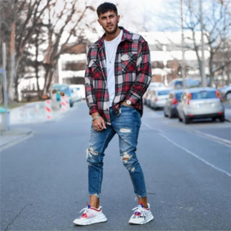 Men's deep blue jeans with distressed hole detailing on cotton denim fabric