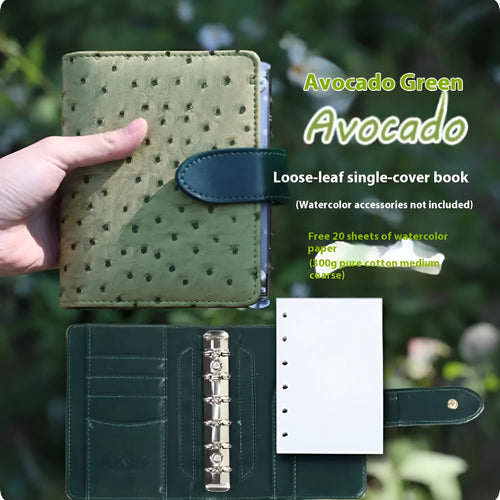 A7 format loose-leaf watercolour notebook in green, shown open on a page with a watercolour wash.